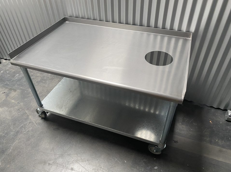 Stainless steel equipment stand with a drilled top and lower shelf